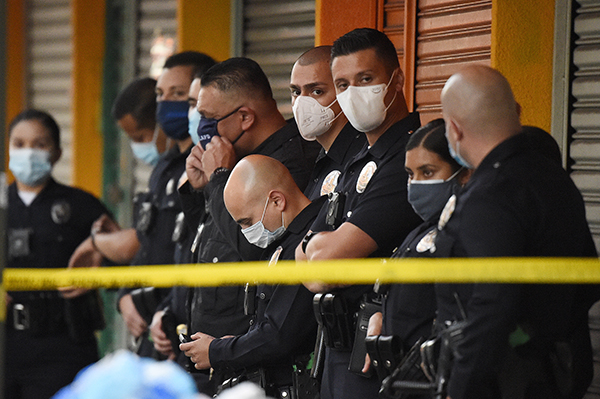 Los Angeles Police Department officers stand at the scene of a structure fire on May 16, 2020. AP Photo/Mark J. Terrill