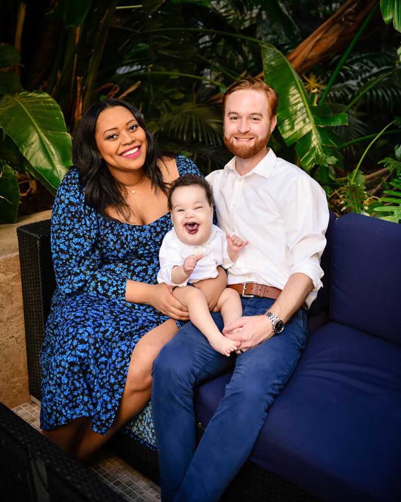 Maya and Dillon Genung hold their son Henry in a family portrait. Image courtesy of Maya Genung