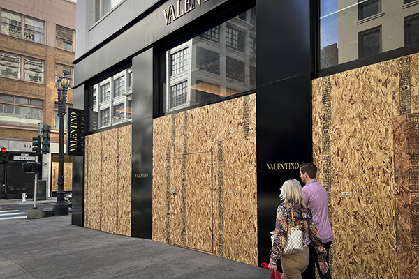 The windows of the Valentino store in Union Square in San Francisco were boarded up on Nov. 25, 2021. Videos on social media showed masked people running with goods from several high-end retailers in the storied shopping area. Photo by Samuel Rigelhaupt / Sipa USA
