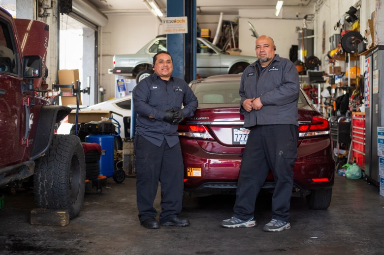 Jesús Rojas, right, and Raúl Man Pérez, left, co-owners of J & R Auto Repair are photographed in their shop in San Francisco, Thursday, May 12, 2022. Photo by Nina Riggio for CalMatters